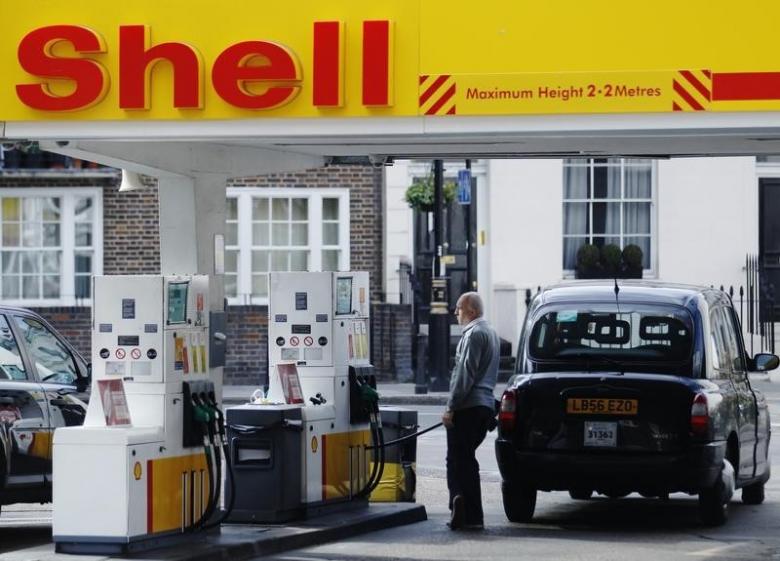 A driver fills up with fuel at a Shell petrol station in London